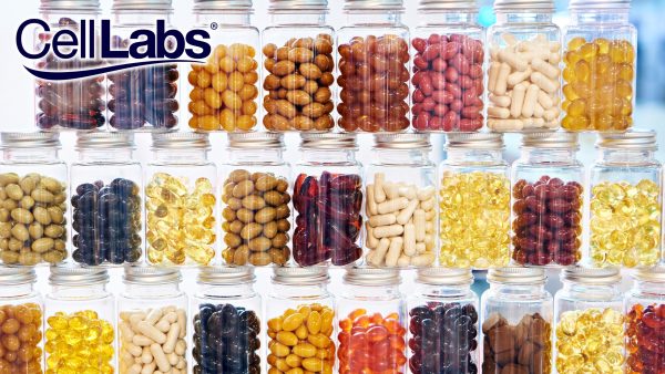 Image of different dietary supplement pills and capsules in glass jars stacked on top of one another.